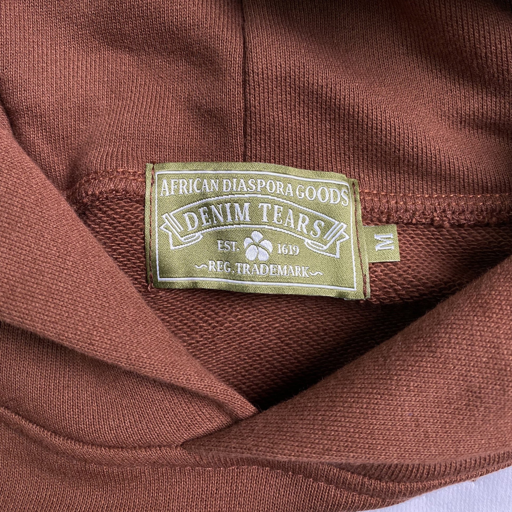DENIM TEARS COTTON WREATH HOODIE BROWN - Phantom Kicks
