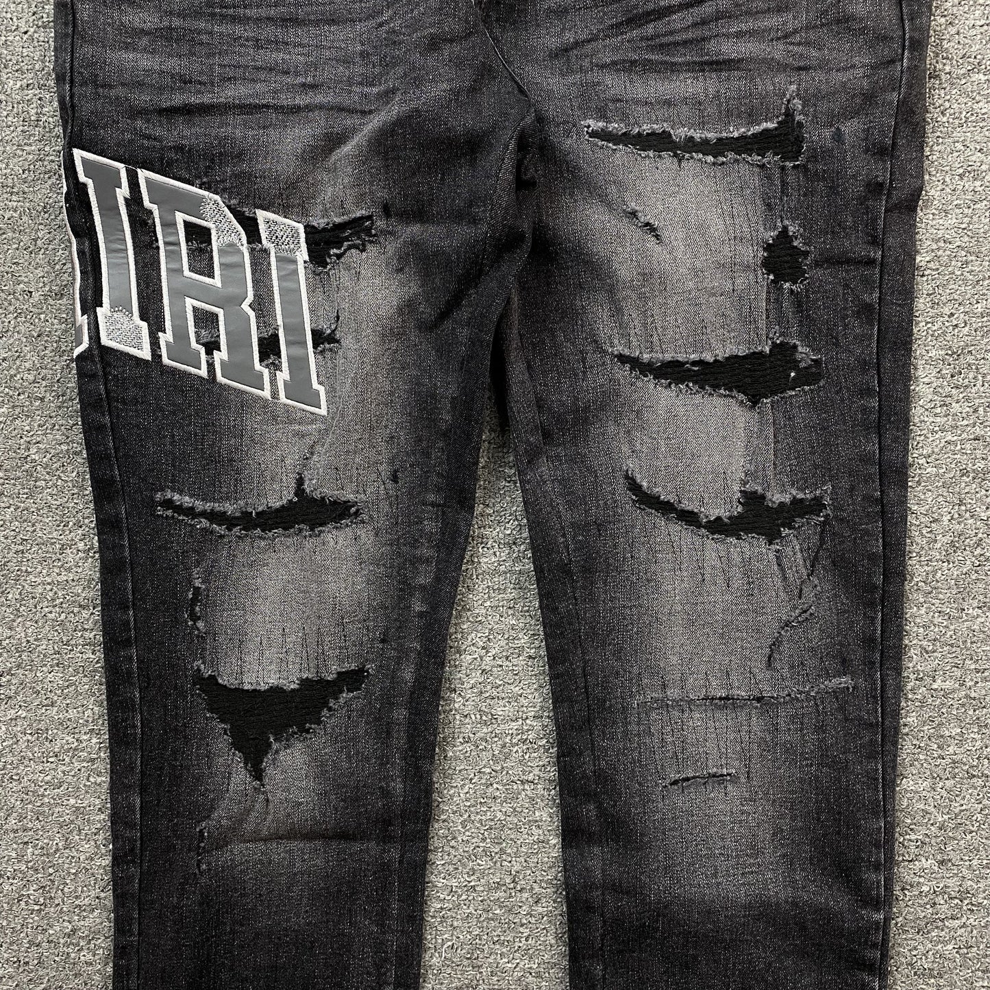 AMIRI VARSITY LOGO REPAIR JEANS - Phantom Kicks