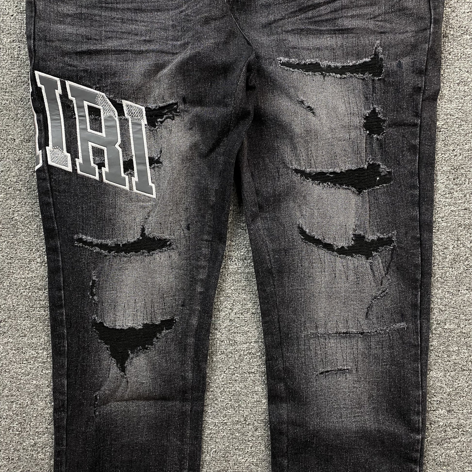 AMIRI VARSITY LOGO REPAIR JEANS - Phantom Kicks