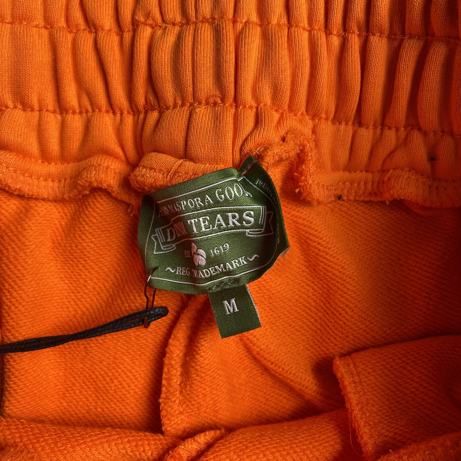 DENIM TEARS COTTON WREATH SWEATPANTS ORANGE - Phantom Kicks